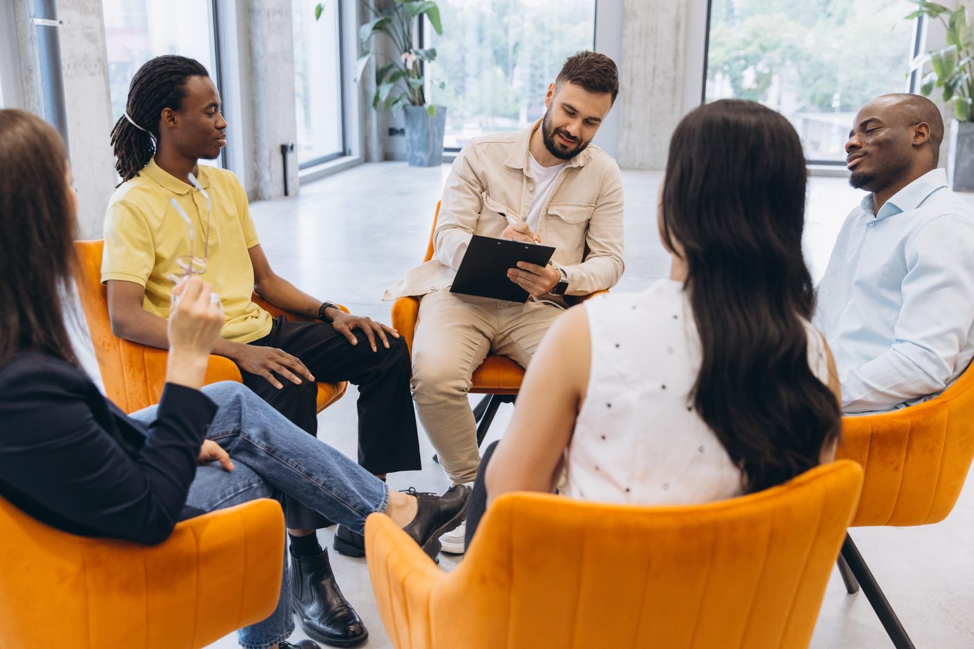 A small group talking in a circle of chairs